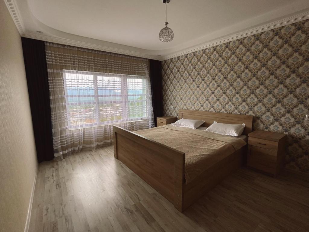 a bedroom with a large bed and a window at LiLu in Telavi