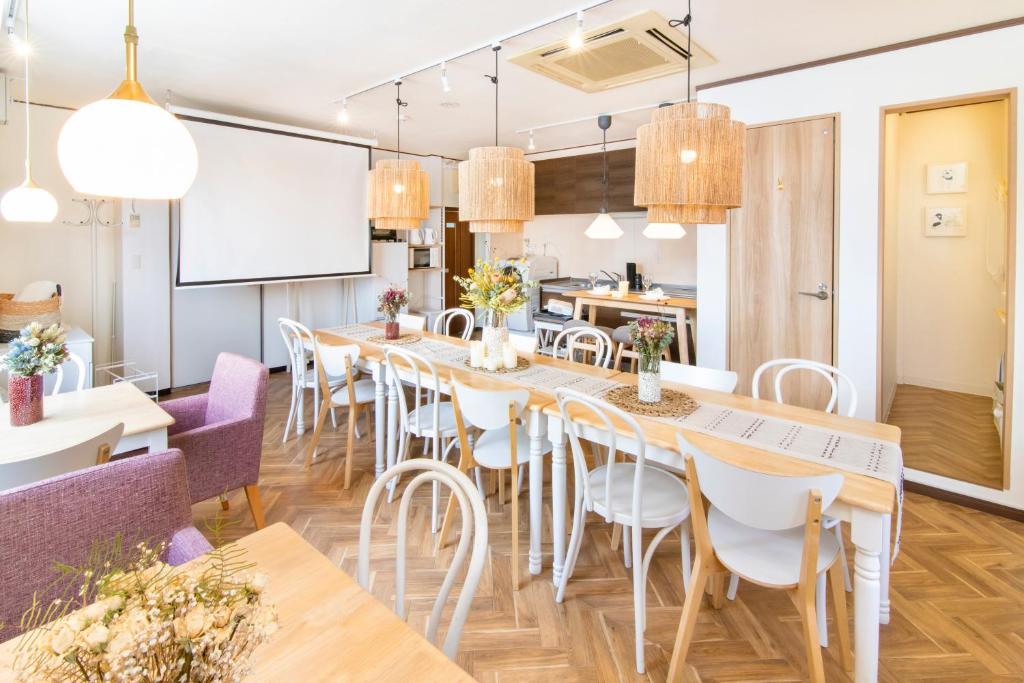 a large dining room with a long table and chairs at Meee Asakusa3F4F 浅草徒歩3分 140平米Max22名 無料駐車場 屋上絶景 渋谷直通 in Tokyo