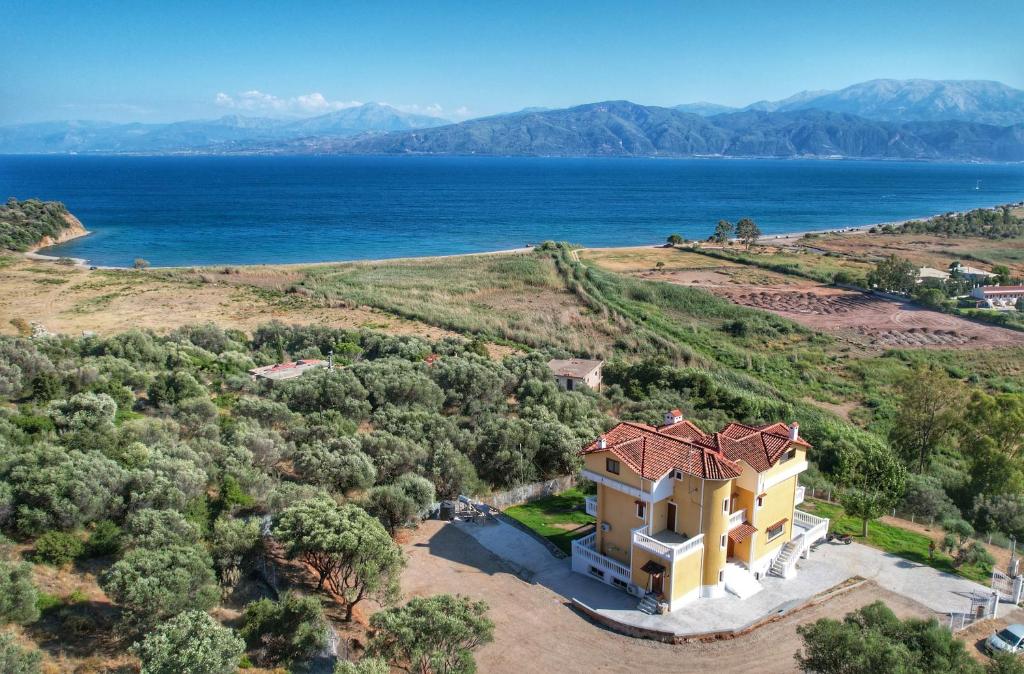 an aerial view of a house on a hill next to the ocean at Majestic View Resort in Nafpaktos