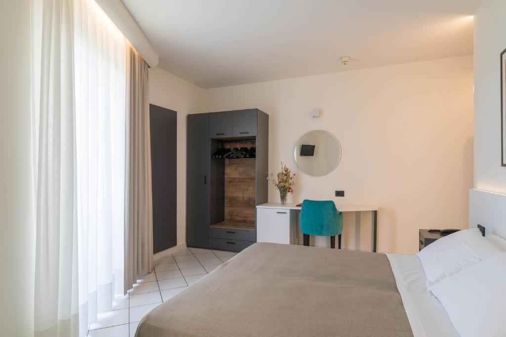 Postel nebo postele na pokoji v ubytování Hotel Lo Smeraldo