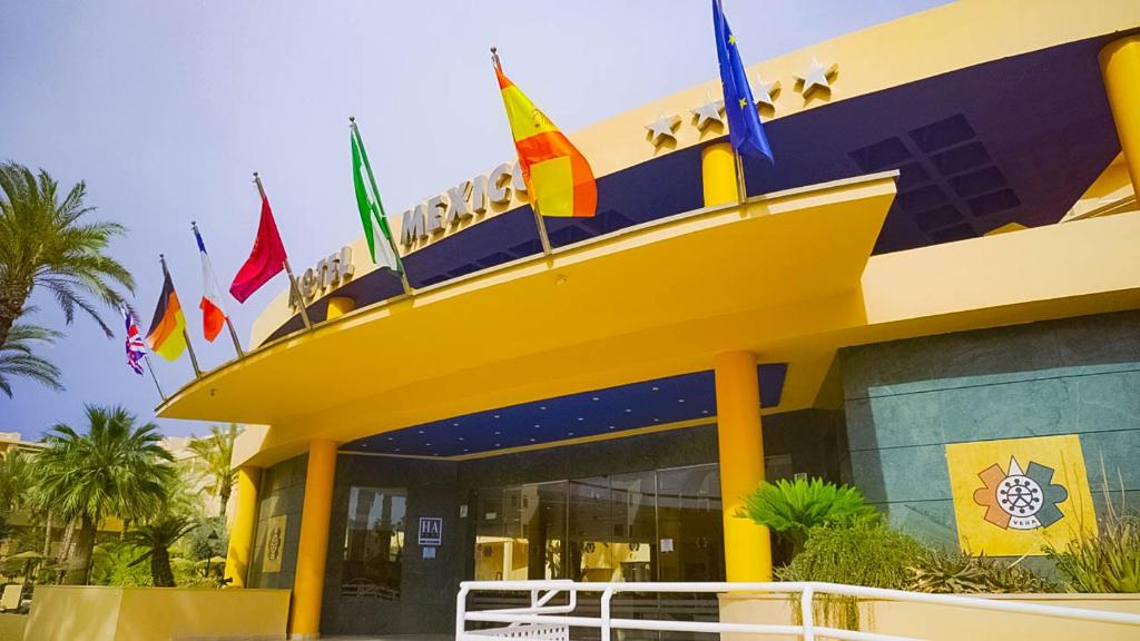 a large building with flags on top of it at Hotel Mexico in Vera