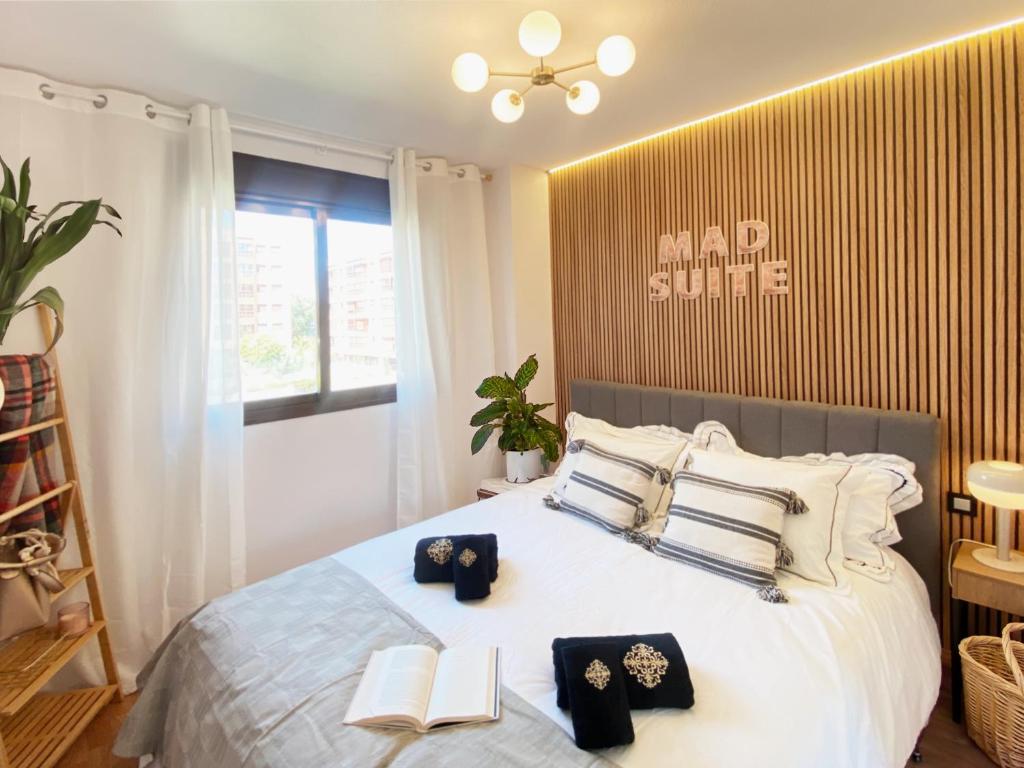 a bedroom with a bed with two books on it at MAD SUITE Aeropuerto IFEMA in Madrid