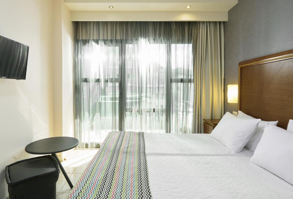 A bed or beds in a room at Mediterranean Resort
