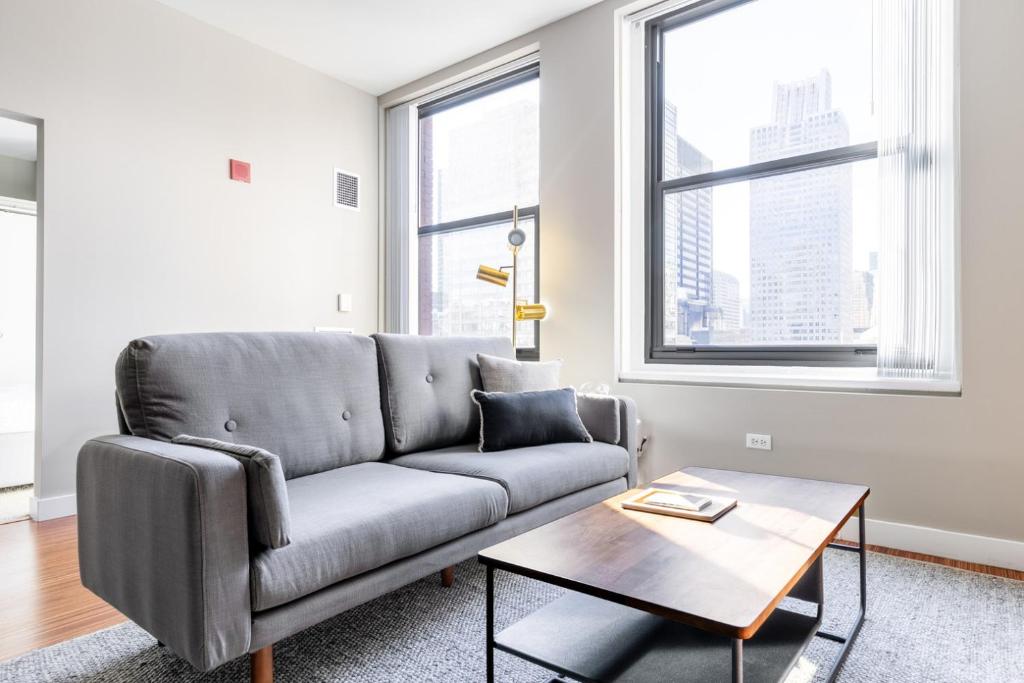 a living room with a couch and a table at Loop 1BR w Gym Roofdeck nr Millennium Park CHI-249 in Chicago