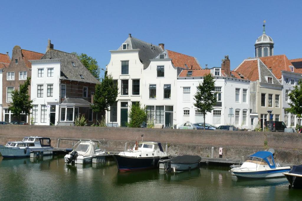 a group of boats docked in the water near buildings at Appartement Middelburg4you in Middelburg