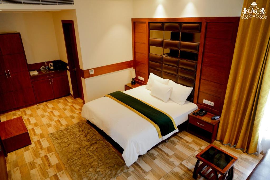 a bedroom with a large white bed in a room at Hotel A9 Barnala in Barnāla