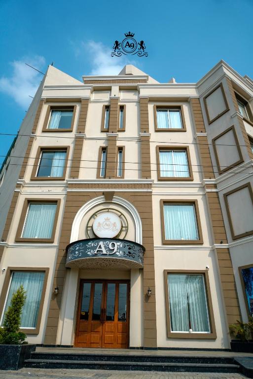 a building with a clock on the front of it at Hotel A9 Barnala in Barnāla