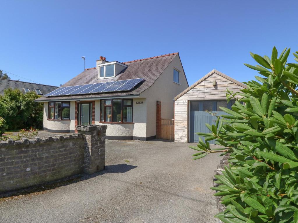 a house with solar panels on the front of it at Awelfryn in Holyhead