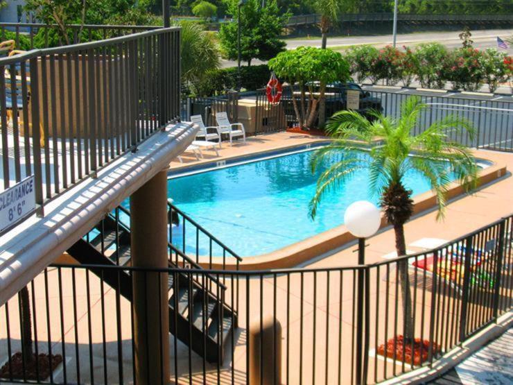 an empty swimming pool in a hotel with a staircase at Tarpon Shores Inn in Tarpon Springs