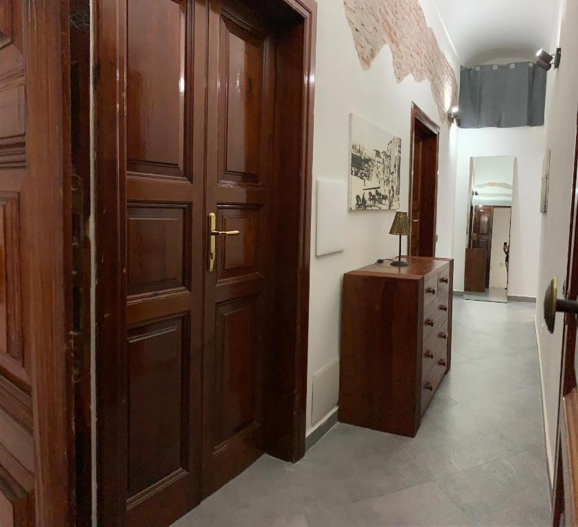 un corridoio con porta in legno e armadietto in legno di La Casa di Dario a La Maddalena