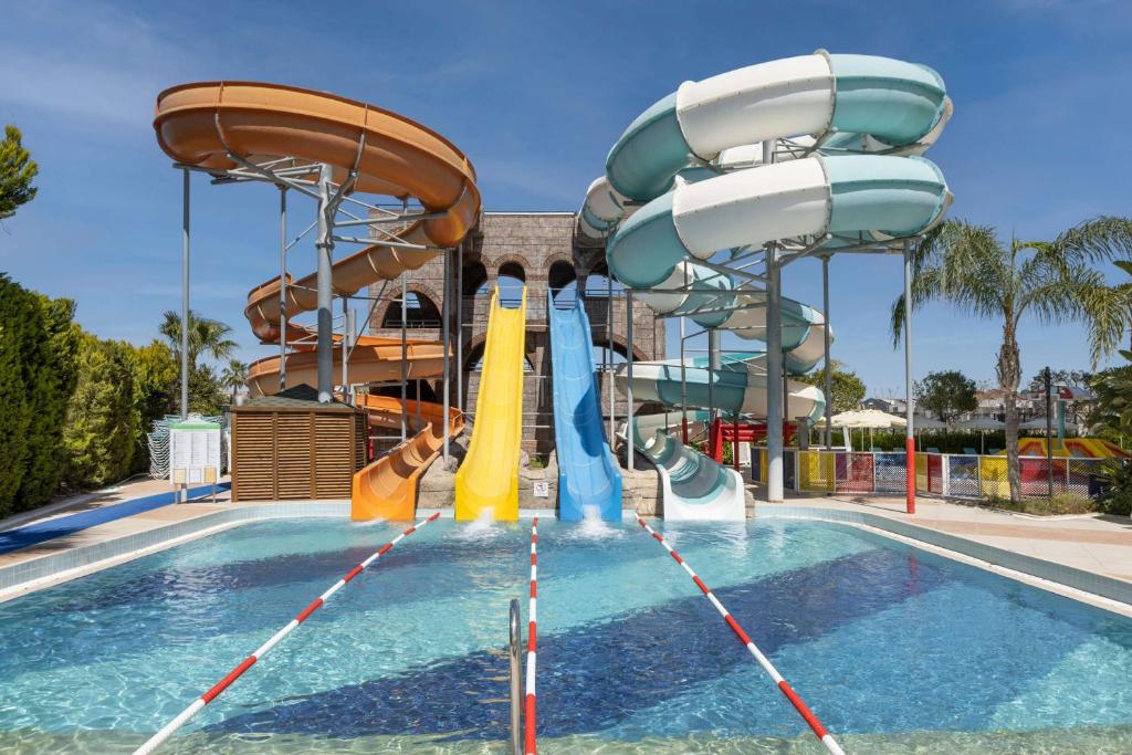 a pool with a water park with slides at Wyndham Garden Lara in Lara