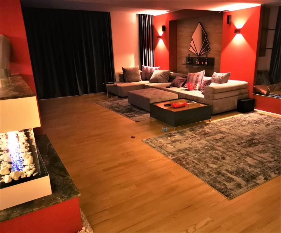 a living room with red walls and couches at NETFLIX & CHILL in Remetea Mare