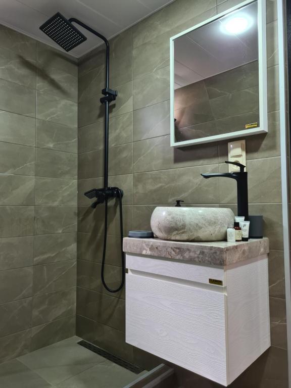 a bathroom with a sink and a shower at Trip Zone Kazbegi in Kazbegi