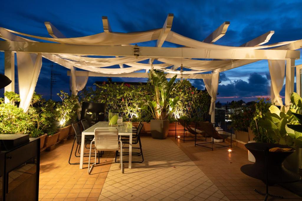 a patio with a table and chairs under a white canopy at Palazzo Monterone in Forio d'Ischia