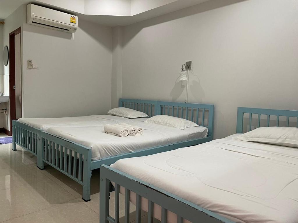 Postel nebo postele na pokoji v ubytování Pudsadee Hotel