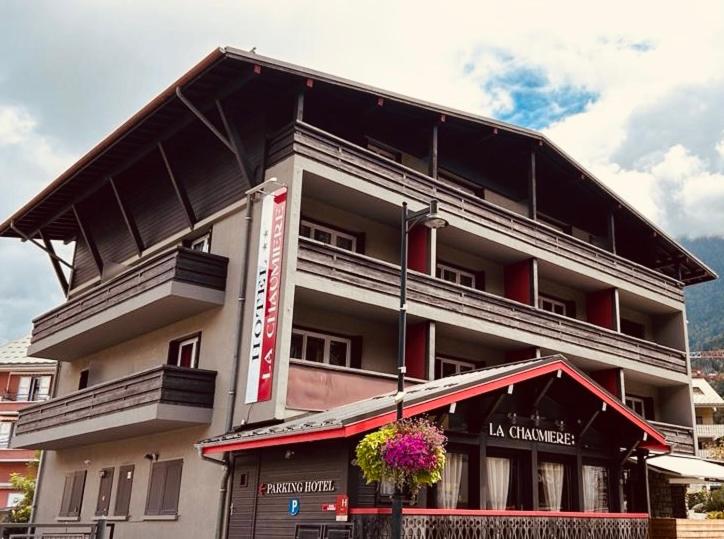 a large building with a balcony on top of it at Hotel La Chaumiere in Saint-Gervais-les-Bains