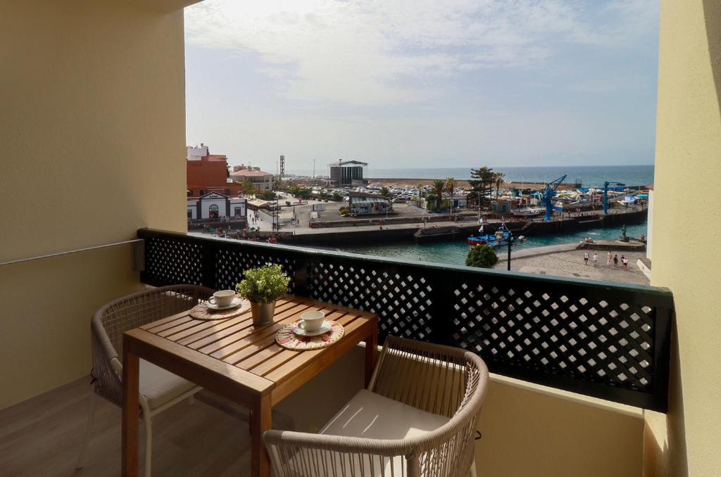 a balcony with a table and chairs and a view of the ocean at SUN-SEA in Puerto de la Cruz