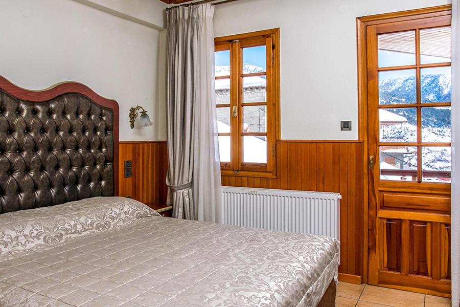 Postel nebo postele na pokoji v ubytování Hotel Apollon