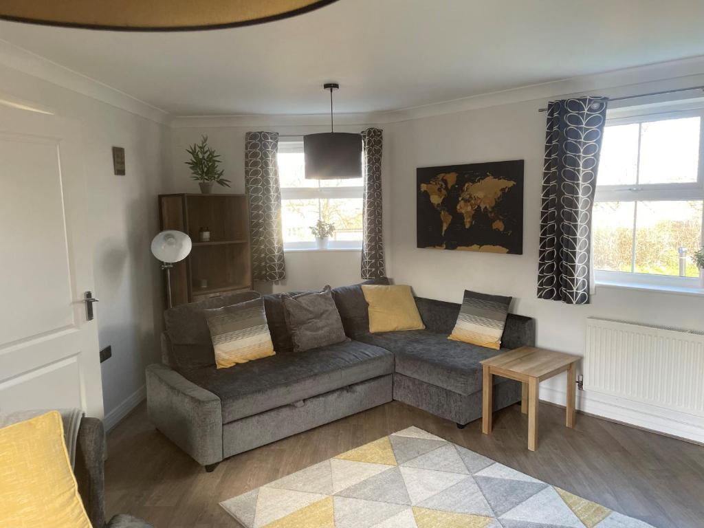 a living room with a couch and a table at Gorgeous 3 Bedroom 2 Bathroom Family Home in Bracknell