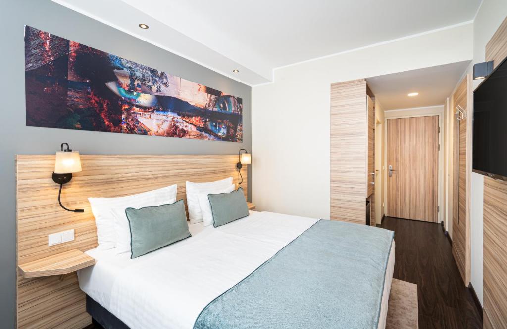 Postel nebo postele na pokoji v ubytování Leonardo Boutique Hotel Linz City Center