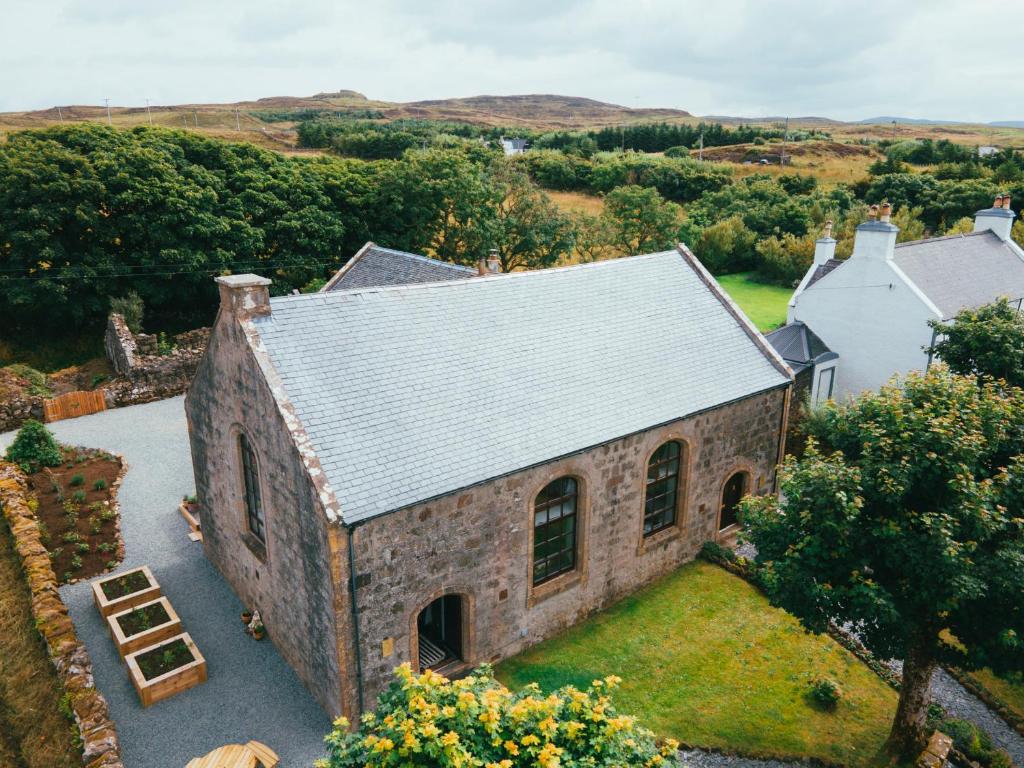 an aerial view of a brick house with a roof at Thomas Telford Lettings - Luxurious Interiors and Seaviews in Halistra