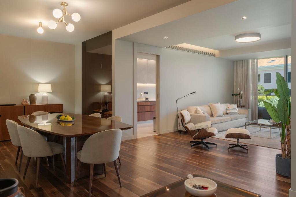 a dining room and living room with a table and chairs at Savoy Residence Casa Branca II by An Island Apart in Funchal