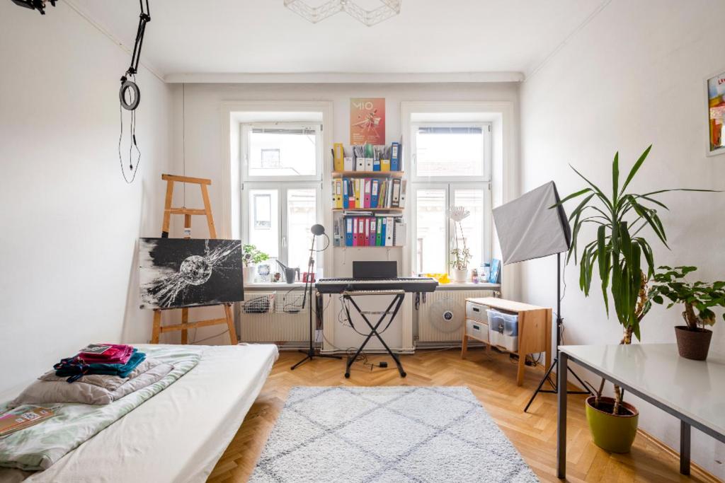 a living room with a bed and a desk at FRO-MEDIA - Streetside Room 2 - Community Space in Vienna