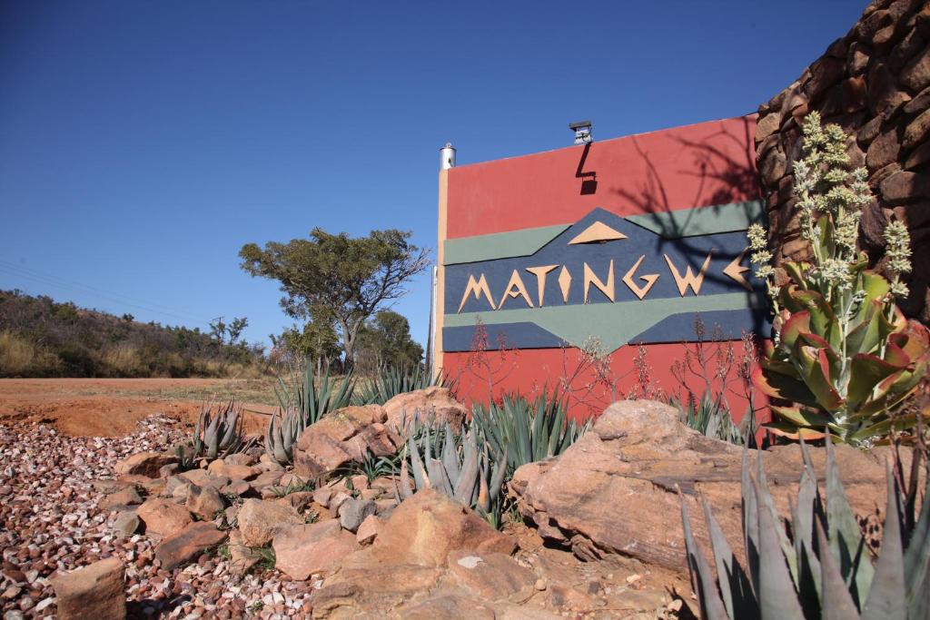 a sign with a painting on the side of it at Matingwe Lodge in Vaalwater