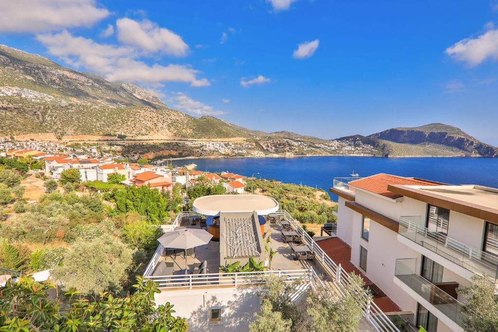 a building with a view of a body of water at Kalkan Saray Suites Hotel in Kalkan