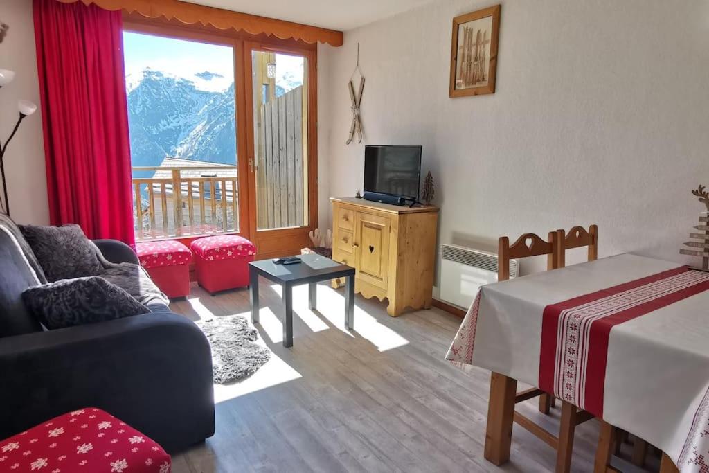 un salon avec un lit, un canapé et une télévision dans l'établissement Les Balcons du Soleil Appt303 à100m pistes 2 chambres parking couvert WIFI, à Orcières