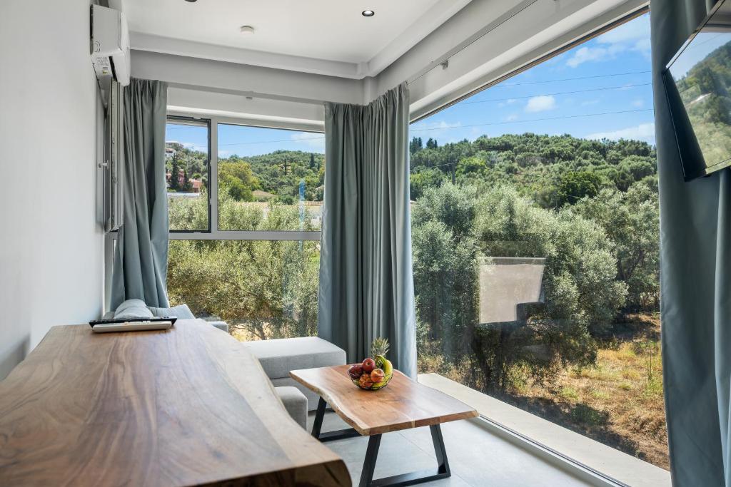 a room with a table and a large window at Robin's in Lefkada