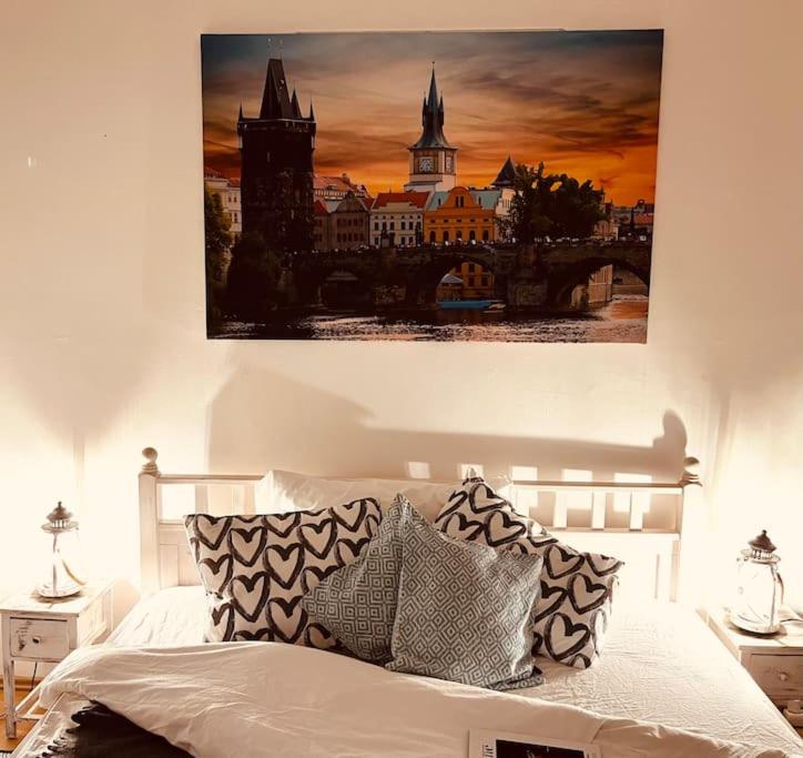 TOP lokalita u Pražského hradu! في براغ: غرفة نوم بسرير مع لوحة على الحائط