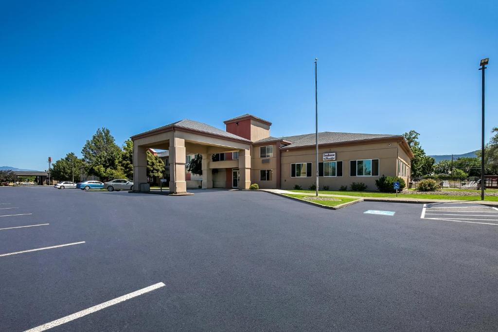 a building with a parking lot in front of it at Americas Best Value Sandman Inn in La Grande