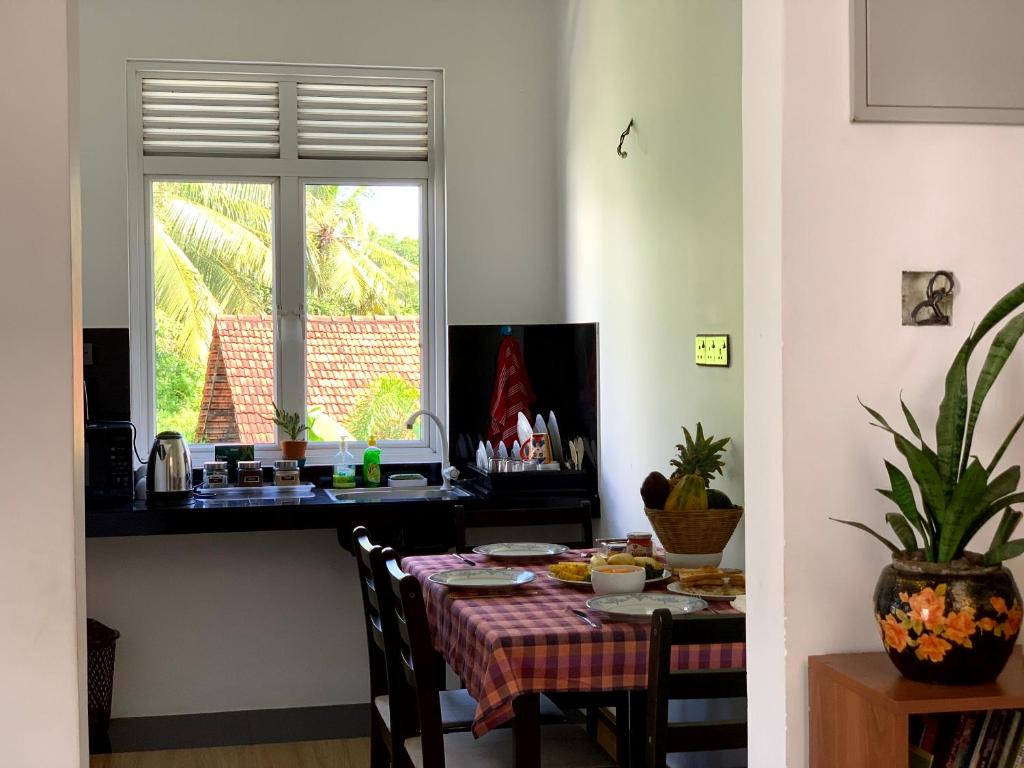 a dining room with a table and a window at Villa Avi - Near Airport in Negombo