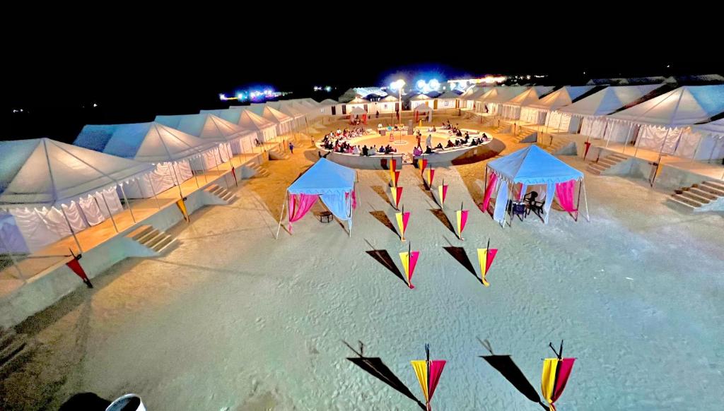 a group of tents with kites on a beach at night at Golden Fort Resort in Jaisalmer
