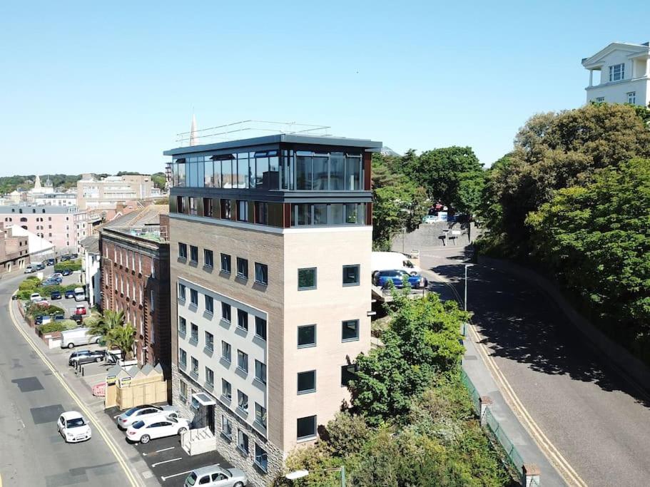 a tall white building with a balcony on top of it at THE PAD by the beach Penthouse apartment with sunset and city views in Bournemouth