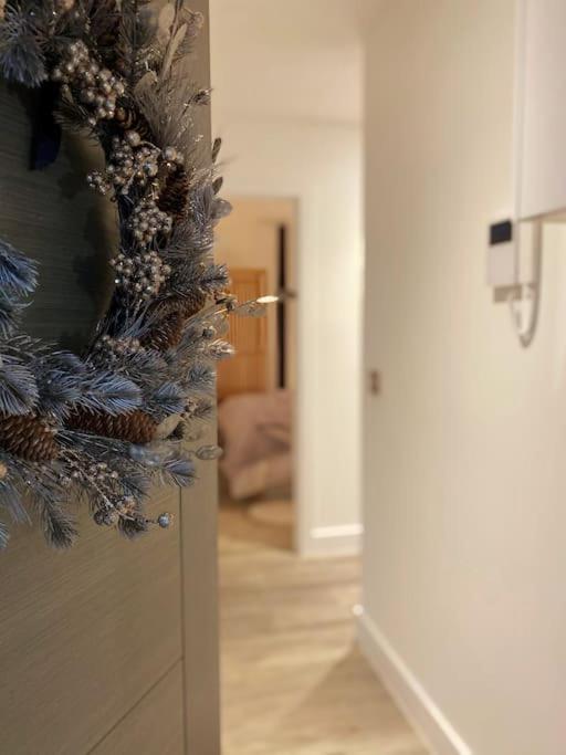 a christmas wreath on a door in a hallway at THE PAD by the beach Penthouse apartment with sunset and city views in Bournemouth