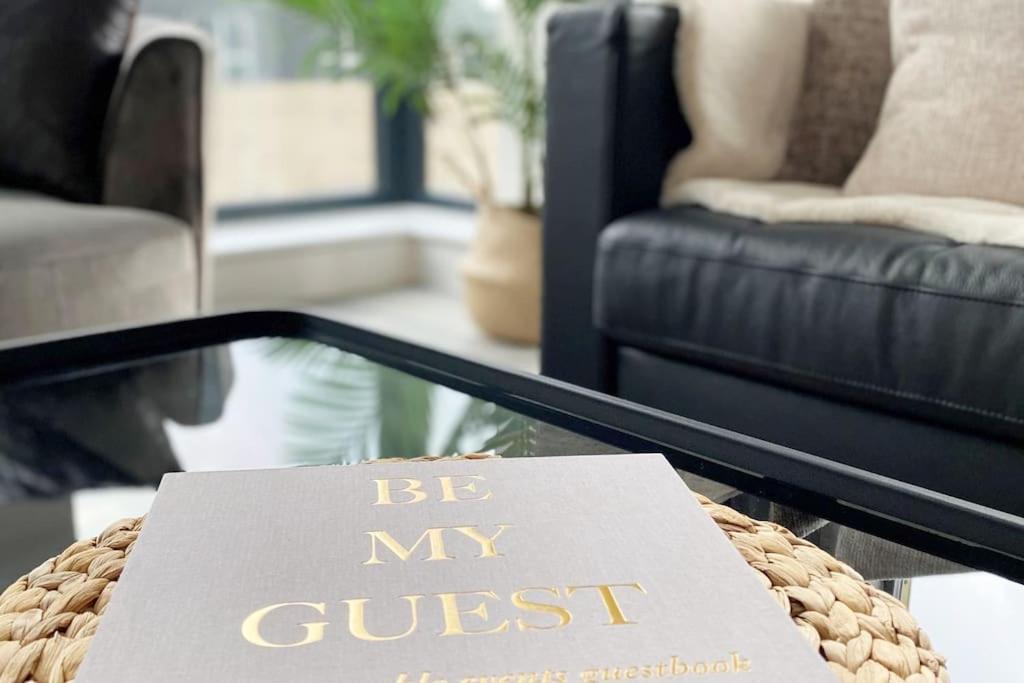 a sign on a coffee table in a living room at THE PAD by the beach Penthouse apartment with sunset and city views in Bournemouth