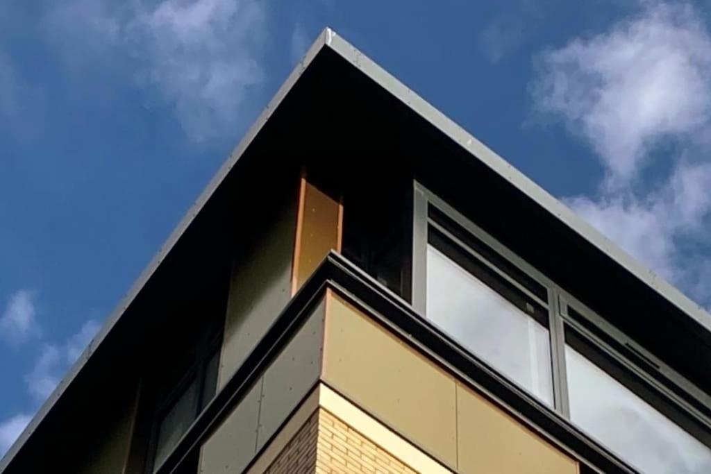 a black building with windows on top of it at THE PAD by the beach Penthouse apartment with sunset and city views in Bournemouth