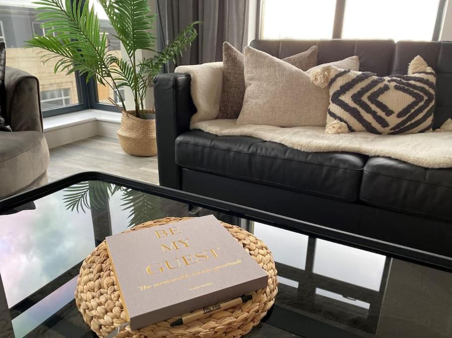 a living room with a couch and a box on a table at THE PAD by the beach Penthouse apartment with sunset and city views in Bournemouth