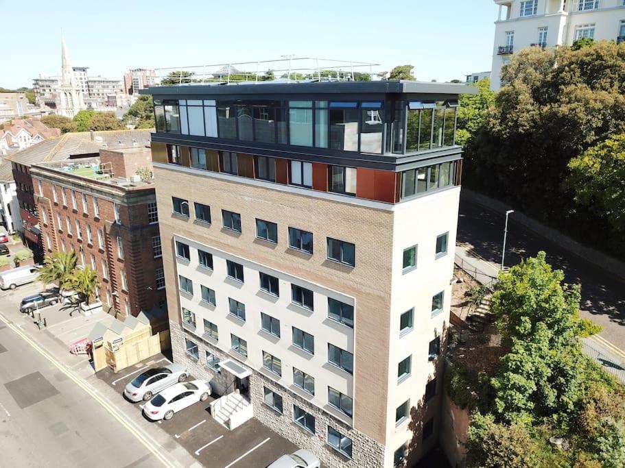 an apartment building with a balcony on top of it at THE PAD by the beach Penthouse apartment with sunset and city views in Bournemouth
