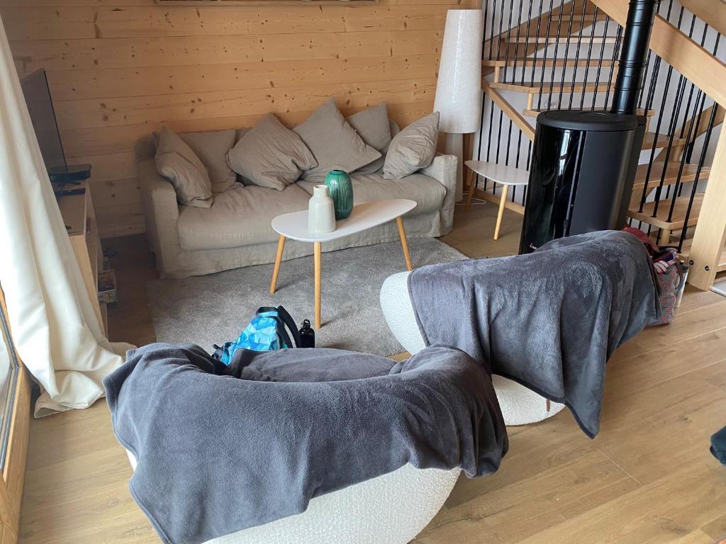 a living room with a couch and a table at Chalet La Mahure in La Toussuire