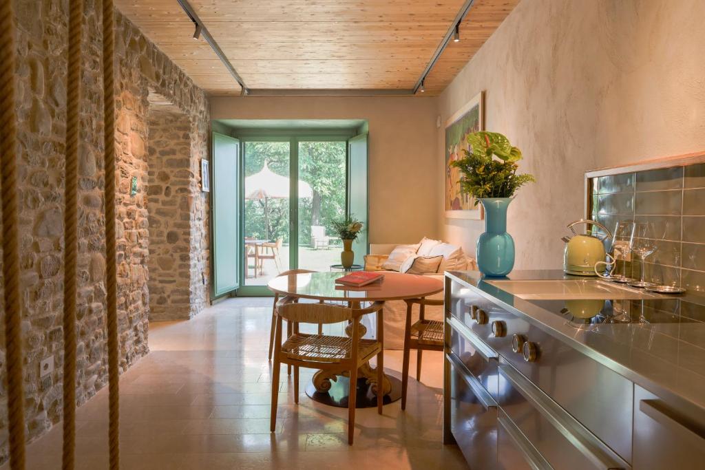 a kitchen with a table and a dining room at Hidden Gabicce in Gabicce Mare