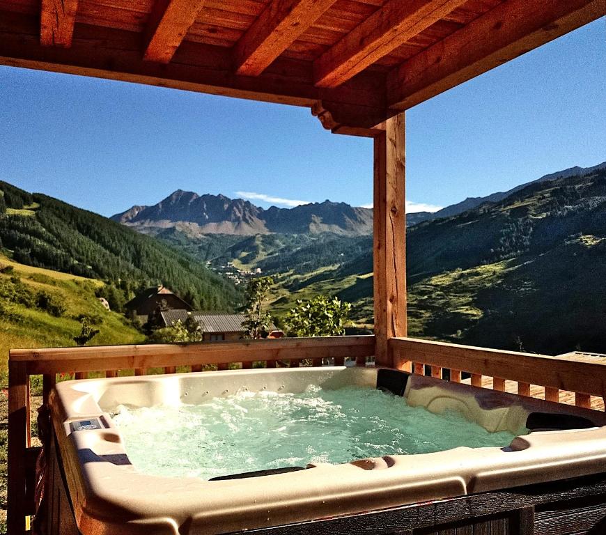 a hot tub with a view of the mountains at Charming Chalet w/ Mountain & Slope Views, Jacuzzi in Vars