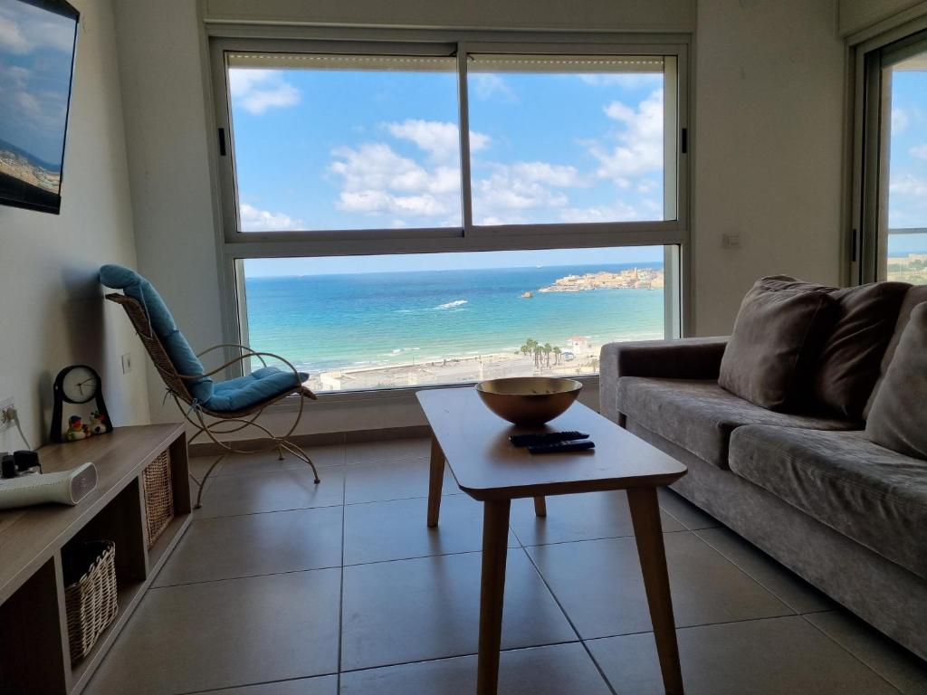 a living room with a view of the ocean at Beachfront Gallery in Acre