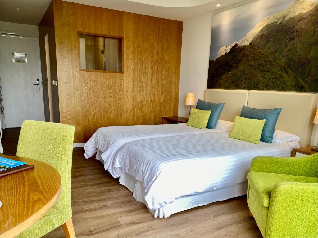 Postel nebo postele na pokoji v ubytování Hotel Tigaiga