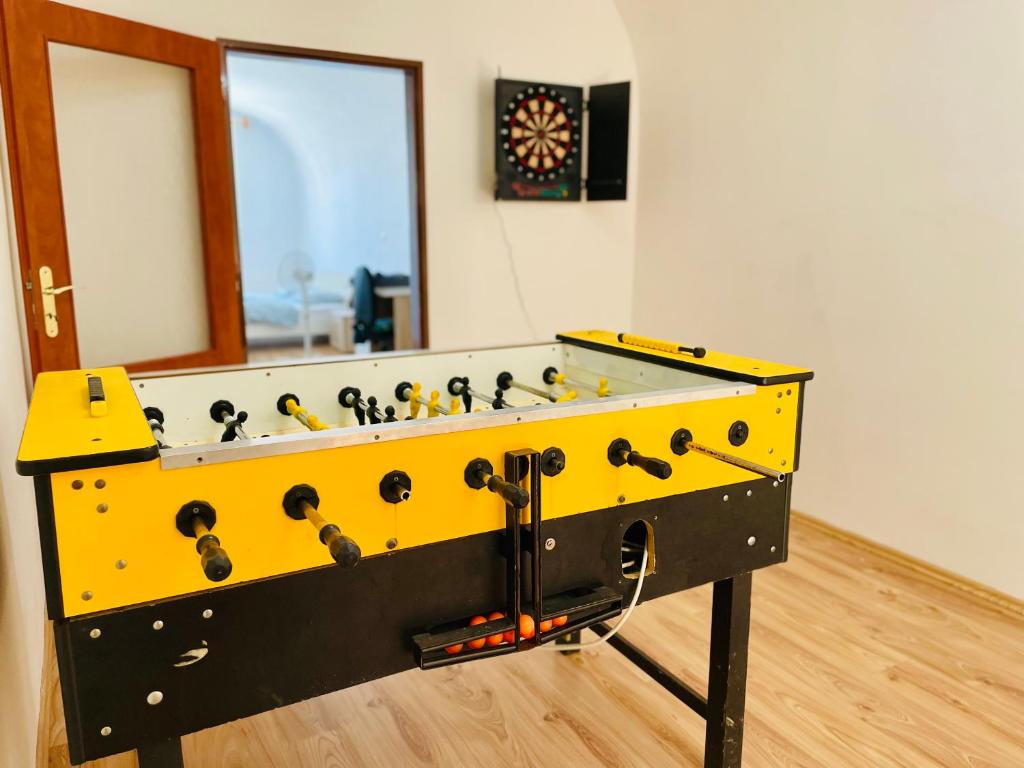 a yellow and black foosball table in a room at Central Apartment Fun & Teambuilding in Košice