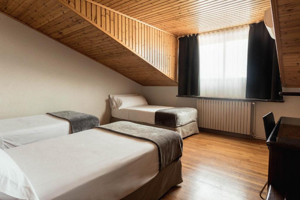 Postel nebo postele na pokoji v ubytování Hotel Terradets