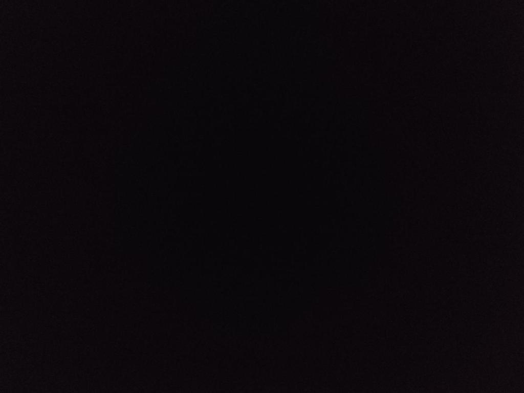 a dark room with a black background at Μουχτή Καμπάνη Οικεία in Petra