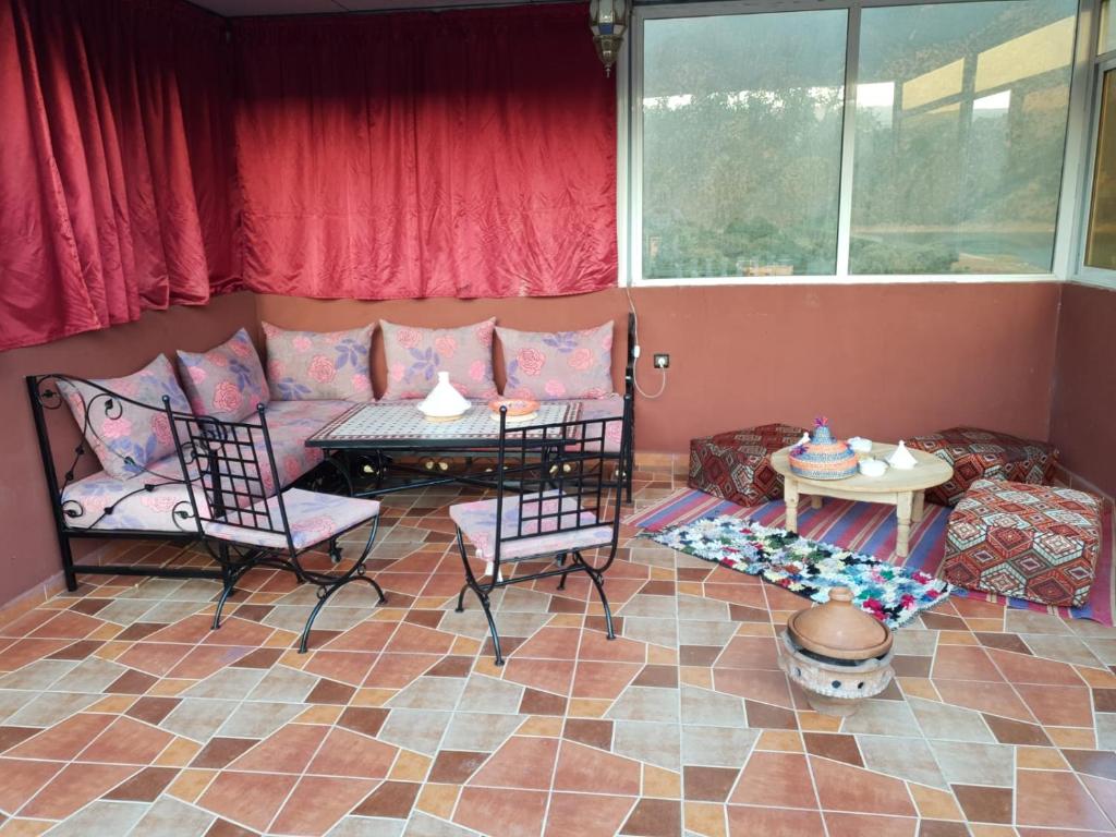 a living room with a couch and chairs and a table at Ouirgane marrakech lhawz in Agouni